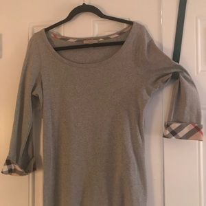 Burberry 3/4 sleeve T-shirt with plaid cuffs.